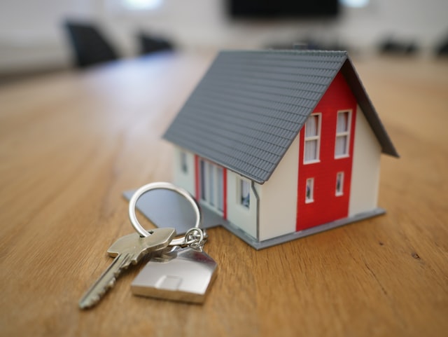 keys next to a red house figurine